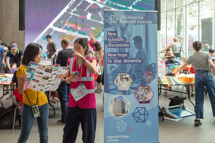 Volunteer helps member of the public with directions at the festival